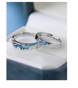 Macro shot of S925 silver Van Gogh Starry Night couple rings with blue enamel