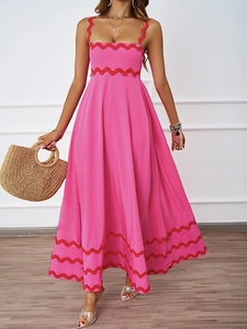 Rose pink summer maxi dress with red scalloped trim and a flared A-line silhouette