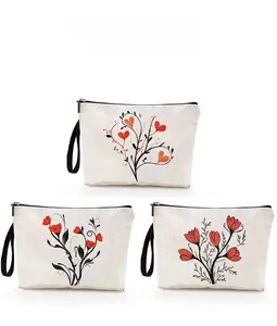 Detailed pattern display of canvas cosmetic bags with floral and heart prints and wristlets