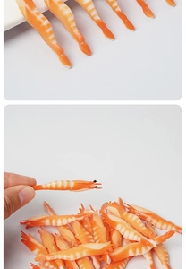 Macro view of miniature PVC cooked shrimp models being held to show small 5cm scale