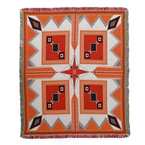 Bohemian orange woven picnic blanket with geometric patterns and fringe tassels