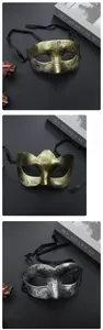 Detailed view of gold and silver vintage masquerade masks with black ribbon ties