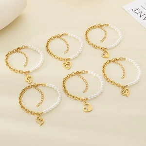 Golden heart pendant bracelet featuring white pearls and titanium steel chain stitching