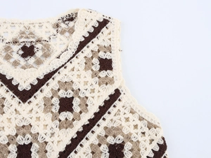 Detail of hand-crocheted hollow knit vest with geometric floral patterns and fringe