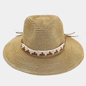 Stylish gold straw sun hat with decorative tassels and wide brim for beach vacations
