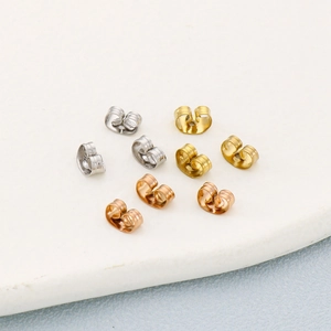 Macro shot of gold, silver, and rose gold stainless steel butterfly earring backs