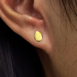Minimalist S925 sterling silver golden oval stud earrings worn by a model for daily style