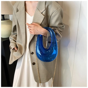Blue transparent acrylic box bag with irregular U-shaped design and gold chain strap