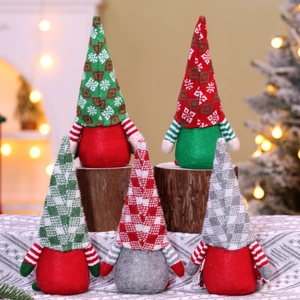 Group of five Christmas gnomes with knitted hats in red, green and grey on wooden stands