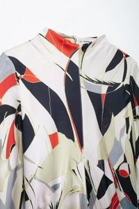 Detail view of the abstract geometric pattern on this elegant satin fabric shirt dress