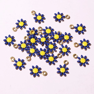 Macro shot of blue enamel flower charms with gold plating for DIY jewelry making