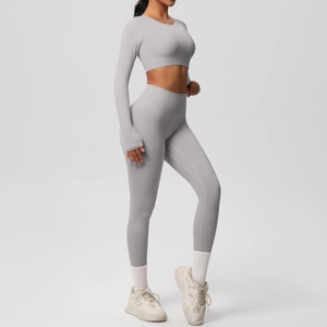 Detail view of light grey nylon yoga set featuring thumb hole cuffs and high waist leggings