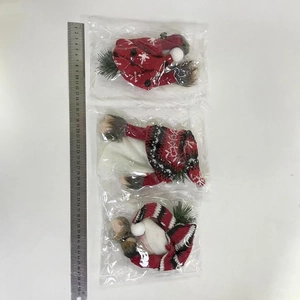 Three Christmas knitted gnome hats and accessories shown next to a 50cm ruler for scale
