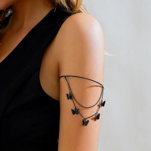 Detail of gothic black butterfly tassel armlet with multi-layered chain and pendants