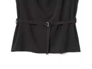 Detailed view of the black waist belt featuring a polished silver D-ring buckle