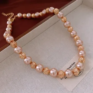 Retro necklace with 10mm pink glass pearls and golden hollow spheres in a luxury set