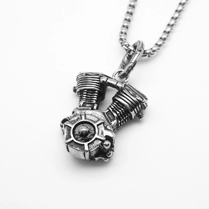 Macro shot of silver titanium steel motorcycle engine pendant with detailed V-twin design