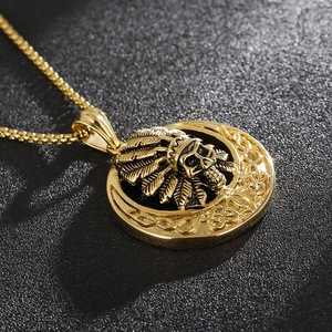 Macro shot of gold skull necklace with Indian chief feather headdress and Celtic patterns