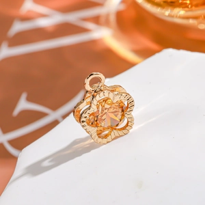 Macro detail of a 14K gold plated flower pendant with a bright yellow zircon stone