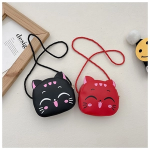 Detail of red and black kitten crossbody bags with woven straps and cute cat face print