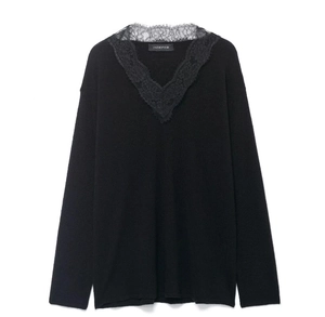 Close-up of elegant black wool blend sweater with delicate lace trim on V-neckline