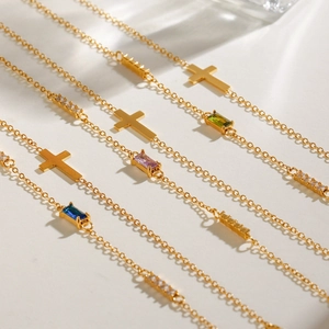 Adjustable stainless steel cross bracelet with colorful birthstone charms in gold finish