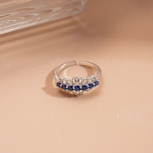Detail of silver adjustable ring with seven blue gemstones and sparkling cubic zirconia