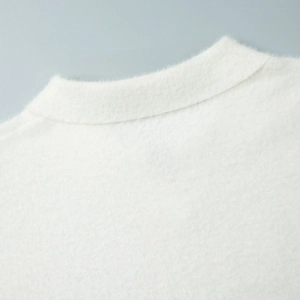 Close-up of premium white fluffy knit fabric texture and polo collar detailing