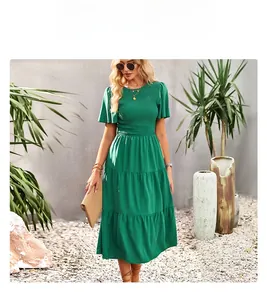 Detail of smocked waist and tiered ruffle hem on a green summer maxi dress