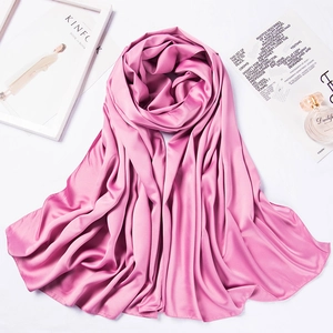 Macro shot of pink matte satin bawal scarf folded elegantly with stylish fashion props