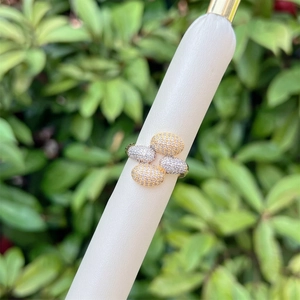 Detailed view of two-tone pavé set zircon ring with interlocking oval design on a display stand