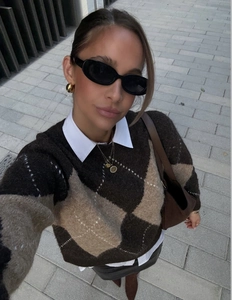 Top view of argyle knit sweater with diamond pattern and stylish fashion accessories