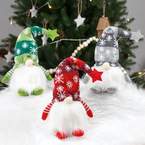 Three glowing Christmas gnomes with knitted hats and white beards on a snowy rug