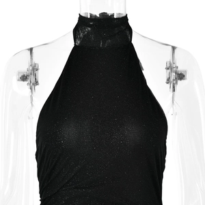 Detail shot of the backless halter neckline and shimmering black fabric on a dress