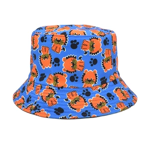 Detail of blue cotton bucket hat featuring orange cartoon lion and paw print patterns