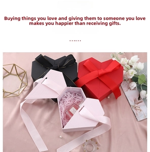 Detailed view of heart-shaped gift boxes with satin ribbons and geometric faceted design