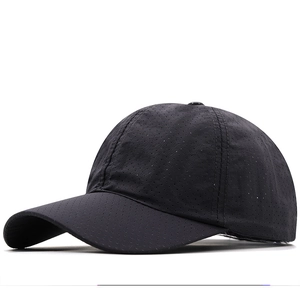 Detail of black quick-drying baseball cap with perforated breathable mesh fabric