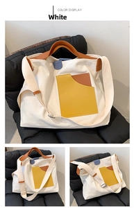 Detail view of large canvas tote bag with ginger yellow pocket and leather handles