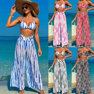 Three-piece women's swimwear set with halter bikini and printed high-waist wide-leg pants
