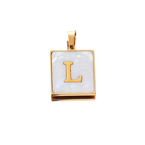 Macro view of a 22mm gold stainless steel square pendant with shell inlay and letter L