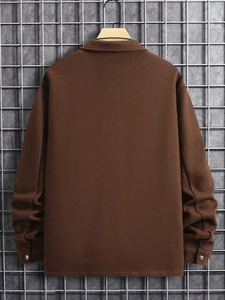 Rear view of brown corduroy work jacket with lapel and metallic cuff buttons