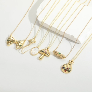 Detailed view of various gold-plated pendants with mushroom and insect motifs on O-chains