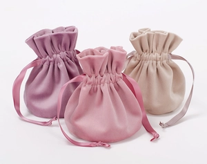 Three premium velvet drawstring gift bags in purple, rose pink and beige colors