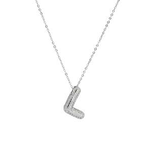 Detailed macro view of silver bubble letter L pendant with pavé zircon stones