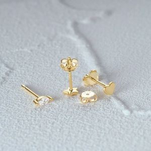 Macro shot of 925 silver gold-plated heart, star and zircon stud earrings set