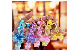 Group shot of colorful starfish liquid glitter keychains with Happy Moments wrist straps