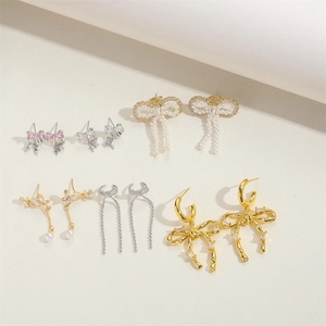 Detailed collection of elegant bow earrings in gold, silver and pink with pearls