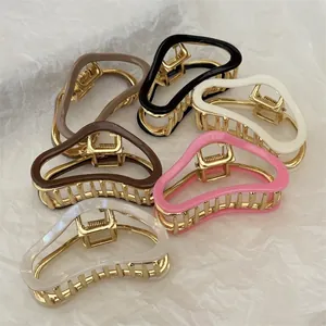 Set of six colorful cloud-shaped hair claws with golden metal base and resin finish