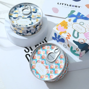 Detail view of 80g tin cans with easy-pull lids and matching patterned gift box packaging