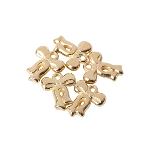 Detailed close-up of five shiny gold metallic bow pendants for DIY jewelry making